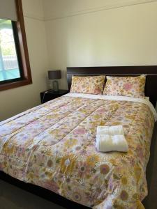 a bedroom with a large bed with a pillow on it at Cheerful 2 bedroom house with a beautiful veranda in Geelong