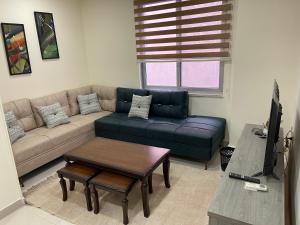 a living room with a couch and a table at Apartment for rent 50M fully furnished -completely new in Amman