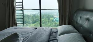a bed in a bedroom with a large window at Peacehome 31 in Cyberjaya +21 photos