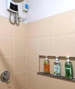 a bathroom with two bottles of soap on a shelf at Verdon Parc 2Br Comfy Resort facing Samal island! in Davao City