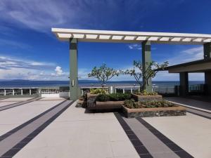 a pavilion with a view of the ocean at Verdon Parc 2Br Comfy Resort facing Samal island! in Davao City