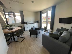 a living room with a couch and a table at Marinaveste Campevaer in Sneek