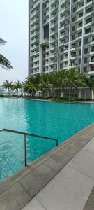 a large swimming pool in front of a large building at Peacehome 31 in Cyberjaya