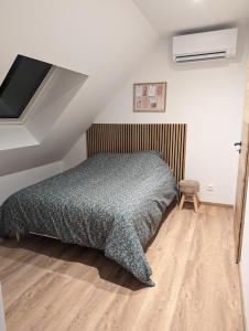 a bedroom with a bed and a television in it at Le Cosy (20' Strasbourg en Bus) in Marlenheim