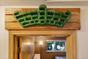 a green wreath on top of a bathroom door at Basecamp Cabin in Greenwater