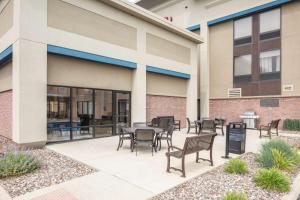 a patio with chairs and tables outside of a building at Hampton Inn Joliet/I-55 in Joliet