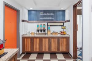 a bar in a restaurant with an orange door at Hampton Inn Joliet/I-55 in Joliet