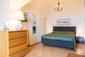 马萨鲁布朗斯Villa Marghe - Sea View Rooms的一间卧室配有一张床和一个带灯的梳妆台 更多35张照片