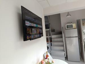 a flat screen tv hanging on a wall in a room at DATA Maisonettes and more in Chios