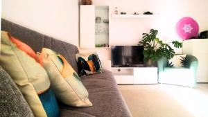 a living room with a couch with pillows on it at Leo's Villa in Milano Marittima +12 photos