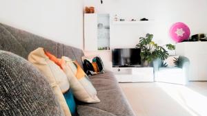 a couch with pillows on it in a living room at Leo's Villa in Milano Marittima