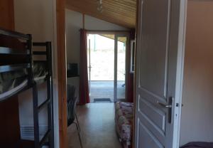 a room with a door open to a room with a bunk bed at Camping Onlycamp Les Peupliers du Lac in Chindrieux +23 photos