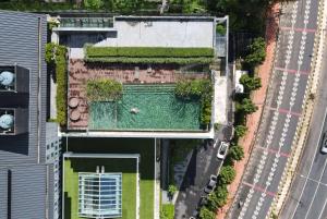 an overhead view of a house with a swimming pool at Ramada Plaza by Wyndham Chao Fah Phuket in Phuket Town
