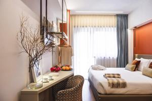 SegniにあるAlbergo La Paceのベッド、テーブル、椅子が備わるホテルルームです。