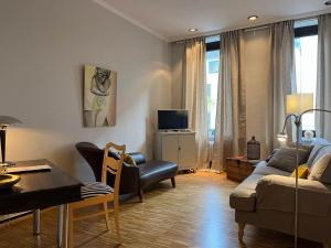 a living room with a couch and a table at Suite Appartement Friesenhof in Hannover