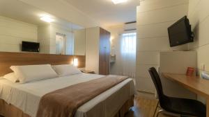 TV a/nebo společenská místnost v ubytování Hotel Glória Blumenau
