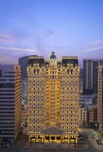 a large building with lights on top of it at Royal Rose Abu Dhabi in Abu Dhabi