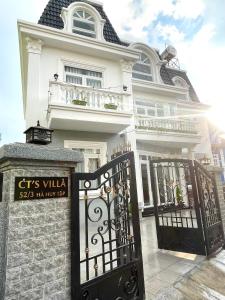 a white house with a gate in front of it at CT Villa in Xuan An