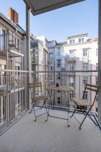 a balcony with two chairs and a table and some buildings at ipartment Berlin Mitte in Berlin
