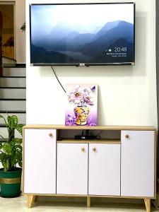 a television on top of a white entertainment center at CT Villa in Xuan An