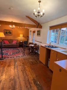 a kitchen and living room with a couch and a table at Hoeve de Knol in Holthees