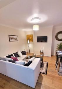 a living room with a white couch and a table at 3-Bed House in Warrington in Warrington