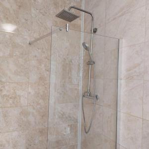 a shower with a glass door in a bathroom at 4-Bed House in Accrington in Accrington