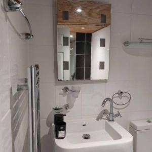 a white bathroom with a sink and a toilet at 3-Bed House in Warrington in Warrington