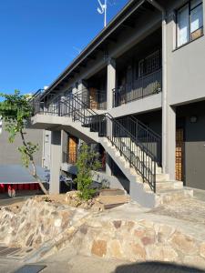 an apartment building with stairs in front of it at Unit 11 - Damara Gardens in Windhoek
