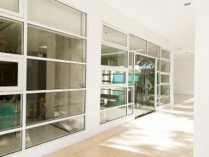 a hallway of a building with glass windows at Studio with mountain view, near Limketkai mall in Prime Cagayan de Oro in Cagayan de Oro