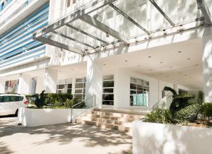 a large white building with stairs and a car at Studio with mountain view, near Limketkai mall in Prime Cagayan de Oro in Cagayan de Oro