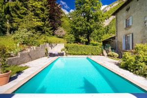 a swimming pool in the backyard of a house at Château Monts Blancs in Lumbin