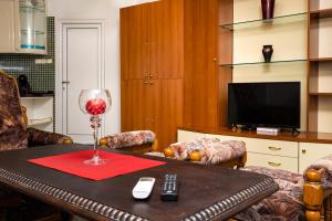 a living room with a table with a wine glass at A Nostalgic Getaway in Plovdiv's Historic Quarter in Plovdiv