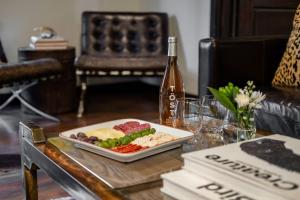 a table with a plate of food and a bottle of wine at LIFT LODGE 102 condo in Park City +43 photos