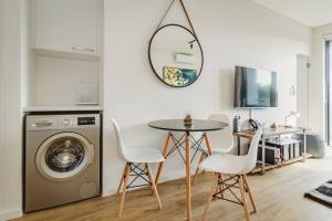 a laundry room with a table and a washing machine at 306 Le Jardin in George