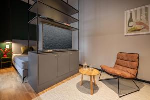 a living room with a chair and a tv at ipartment Berlin Mitte in Berlin