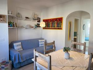 sala de estar con sofá azul y mesa en La casa di Camilla en Cannigione