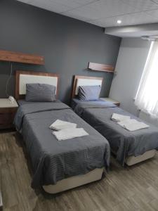 a bedroom with two beds with towels on them at GÜNDOĞDU OTEL in Lapseki