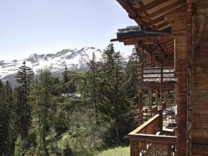 a view of the mountains from the balcony of a cabin at LeCrans in Crans-Montana