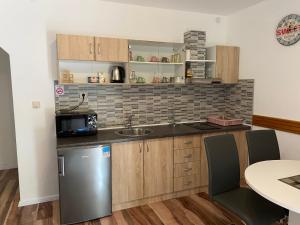 a kitchen with a sink and a counter top at Apartment Liso in Seliste Dreznicko