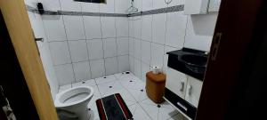 a small bathroom with a toilet and a sink at Estância Oliveira in Socorro +14 photos