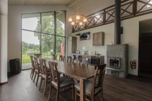 a dining room with a large wooden table and chairs at Holiday home Uzbazes in Valmiera