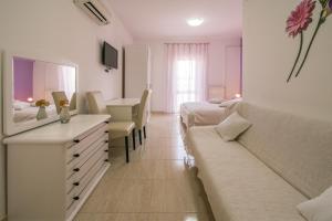 a living room with a couch and a bedroom at B&B Villa Ana in Krk