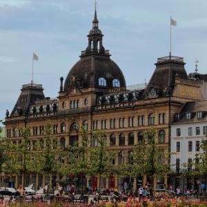 a large building with people sitting in front of it at Stylish 3-BR Flats in CPH City in Copenhagen