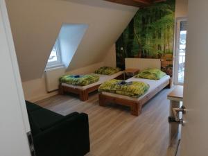 a room with two beds in a attic at Rennsteigscheune in Steinbach am Wald