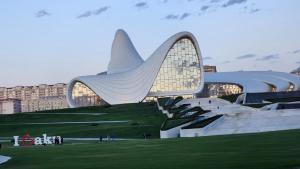 a large building with a building with a pyramid at Xetai Ariva Hotel in Baku