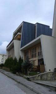 a building with solar panels on top of it at Bjelasnica Mini Studio in Sarajevo