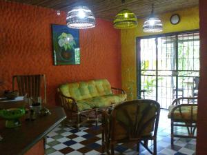 a living room with a couch and chairs and a table at El Castillo Divertido in Para&iacute;so