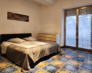 a bedroom with a bed and a large window at La Famosa Dimora Ambasciatore in San Marino