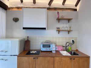 a kitchen with a counter with a microwave and a sink at Hanok Dasi Bom 101 in Gyeongju
